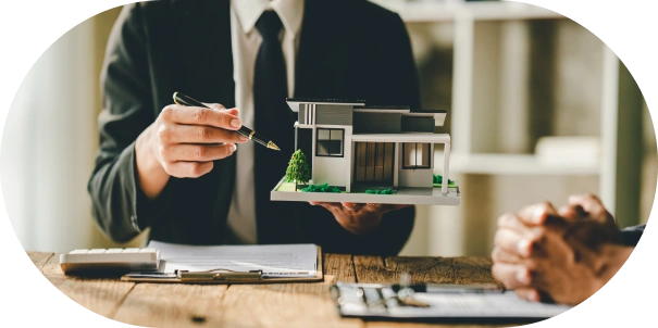 Real estate agent holding miniature house