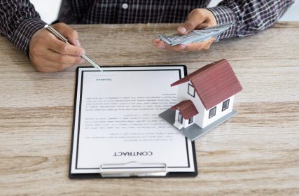 Real estate loan and mortgage contract agreement signing concept.